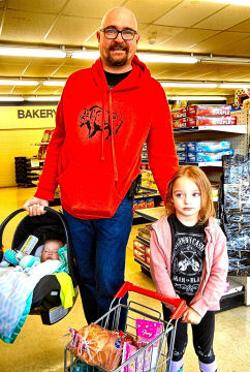 On the day before the Franz Bakery Outlet permanently closed, Allen Sands was shopping for his gluten-free products, and for bakery items for his family. Four year-old Isabelle liked the �kiddy cart�, and 5½ month old Addison slept through the shopping.