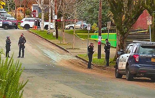 After a noontime shooting wounded a teenage student, officers mark evidence in the street near Cleveland High School.