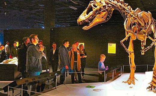 OMSI guests examine a life-sized Tyrannosaurs skeleton at they walk through the new Tyrannosaurs  Meet the Family exhibition.