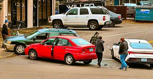After a three-car pileup in Brentwood-Darlington at a dangerous intersection on S.E. 52nd, the drivers involved emerged to inspect the damage. Apparently nobody was hurt.