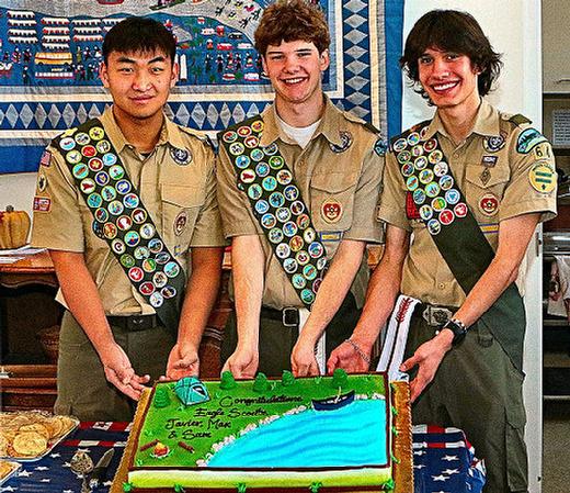 At the March 1st “Eagle Scout Court of Honor” ceremony, here with their celebratory cake are the three latest new BSA Troop 64 Eagle Scouts: From left, Samuel Minzheng Schaller, Maxwell Thomas Deggendorfer, and Javier Alain Mora.
