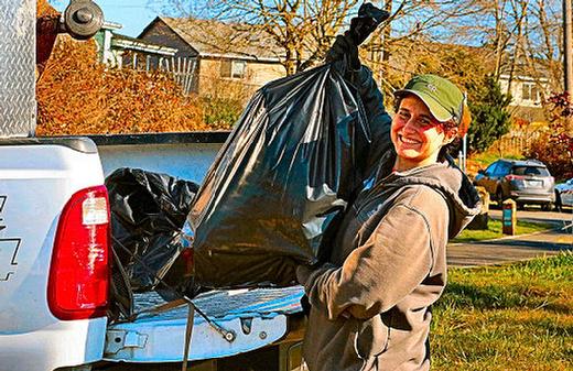 Along S.E. Luther Road, we came across Lauren Cary pitching trash.