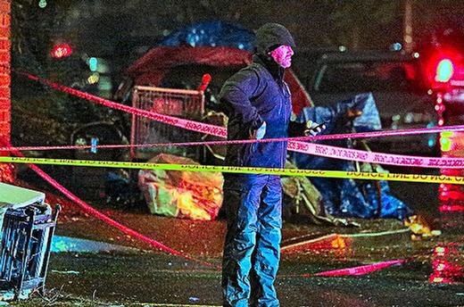 At the March 9th murder scene on S.E. Powell Boulevard, a Portland homicide detective stood in heavy rain at the crime scene, amid a web of police crime-scene tape.