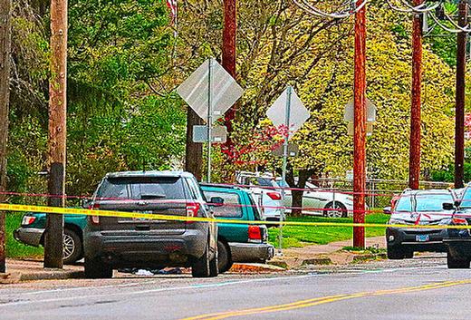 Yellow and red police tape marks off the spot where officers found a stabbing victim inside a Subaru  pulled partly into a driveway, on S.E. Flavel Street  in the late afternoon of Friday, May 5th, across the street from Flavel City Park.