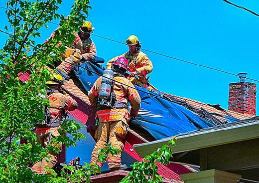 Firefighters covered the solar photovoltaic electric cells with opaque plastic sheeting, so they stop producing potentially dangerous electricity in sunlight, while people are on the roof fighting the fire.