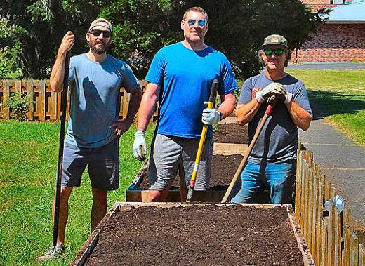Volunteers from the Woodstock Community Church � here including Tevor Wyndham, Greg Burnett, and pastor Patrick Grant � led the volunteer effort to construct planters, and then plant vegetables in them, at the new �food garden� next to the Brentwood-Darlington Community Center.