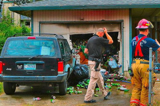 After the garage fire was extinguished, this PF&R Fire Investigator walked in to begin his survey of the charred area inside, which was filled to the top with empty soda cans � evidently collected by the man who was living in the garage.