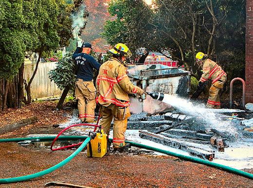 With their water feed line hose hooked up to a container that mixes it with Class A Foam, firefighters drenched timbers cut from the fence and contents of the trash bin, situated behind the PP&R�s Community Music Center, in the Creston-Kenilworth neighborhood.