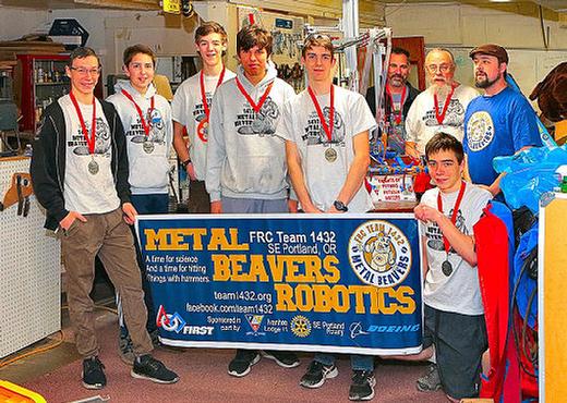 Here are the team members of FRC Team 1432, the Metal Beavers: Elijah Smith, Caleb Corpron, Jonathan Hagen, team captain Ammon Corpron, and Toby Greene; and, lower on the floor, Levi Smith. And in the back, mentors Chad Smith, Alan LohKamp, and Patrick LohKamp back them up. Not present is mascot Declan Marks.